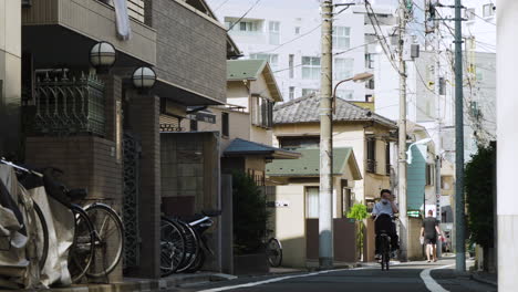 A-lone-cyclist-wearing-a-mask-in-Tokyo-on-a-quiet-Japanese-city-street-during-the-pandemic