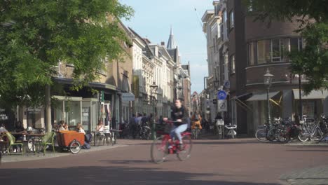 Bicyclists-and-pedestrians-in-busy-Netherlands-city-streets,-Leiden-town-centre