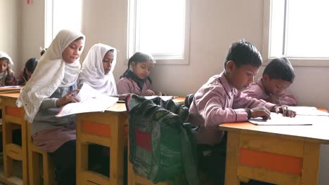 Young-Muslim-Children-Reading-At-Desk-In-Classroom-In-Pakistan