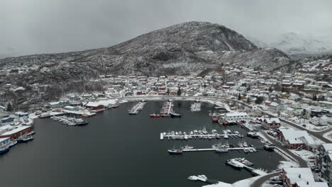 Winter-Panorama-Of-Town-Skjervøy-Covered-In-Fresh-Snow-With-View-Of-Harbor-Shipyard-And-Yellow-Crane,-Northern-Norway