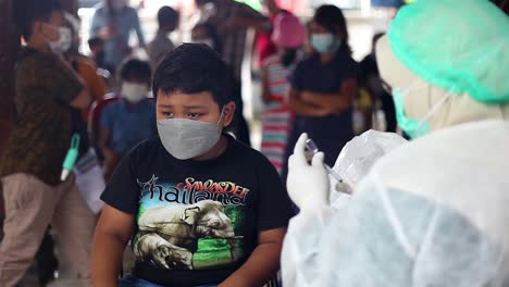 Yogyakarta,-Indonesia---Dec-20,-2021-:-an-elementary-school-boy-is-afraid-to-receive-the-covid-19-vaccine