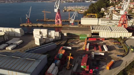 Port-with-large-shipping-containers-being-stored-or-processed-near-a-warehouse-in-Vigo-Spain