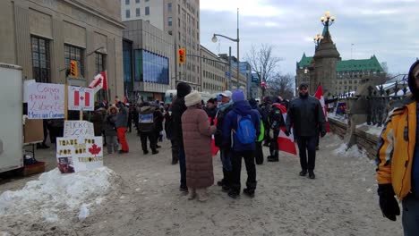 People-protesting-on-Ottawa-Street,-Freedom-Convoy-rally,-Canadian-Flags,-Walking-motion