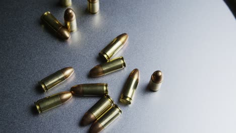 Isolated-bullets-on-a-metallic-table-background,-projectile-ammo-ammunition-top-down-shot