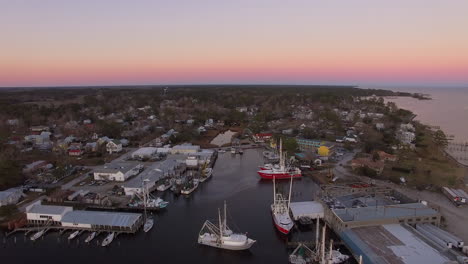 Aerial-Drone-Flyover-of-Oriental-NC-Harbor-and-town-docks-at-sunset-forward-flight-with-Diesel-Spill-facing-north