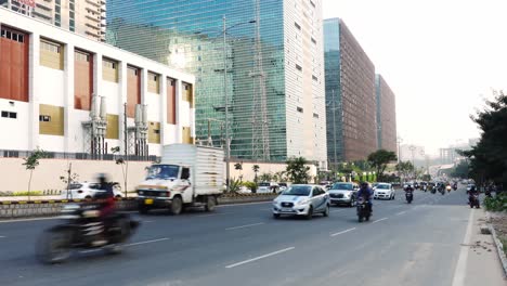 View-of-the-vehicles-moving-on-the-high-way-road-in-front-of-the-high-office-buildings-on-a-summer-day-in-Hyderabad