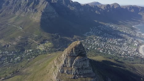 High-aerial-approaches-Lion's-Head-and-Camps-Bay-in-Cape-Town,-ZA