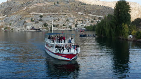 Aerial-View-Of-People-Having-Fun-And-Partying-At-Ferry-Boat-Cruising-At-Euphrates-River-Near-Halfeti-In-Turkey
