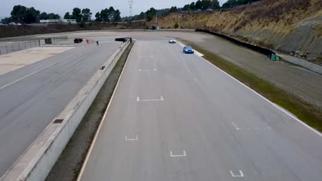 aerial-drone-shot-of-sports-cars-on-a-circuit
