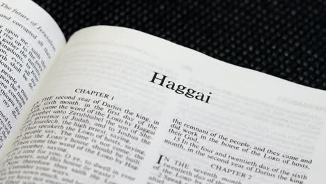 Close-Up-Shot-of-Bible-Page-Turning-to-the-book-of-Haggai