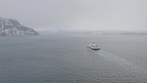 Aerial-View-Of-Ferry-Cruising-From-Olderdalen-To-Lyngseidet-On-Foggy-Kaafjord,-Norway---drone-shot