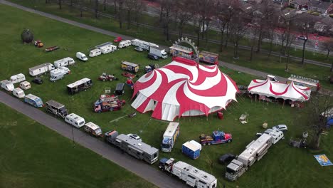 Planet-circus-daredevil-entertainment-colourful-swirl-tent-and-caravan-trailer-ring-aerial-view-tracking-push-in-left