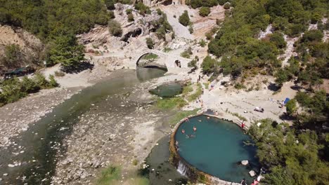 People-Swim-in-Permet-Hot-Springs-and-Thermal-Baths,-Albania---Aerial