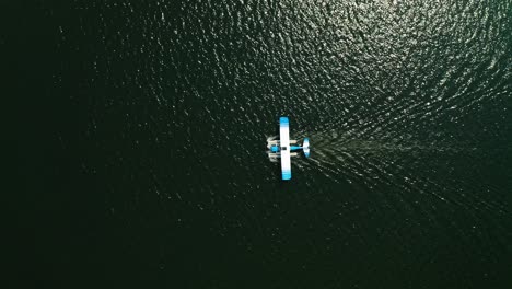 Aerial-top-down,-seaplane-floating-on-ocean-lake-water