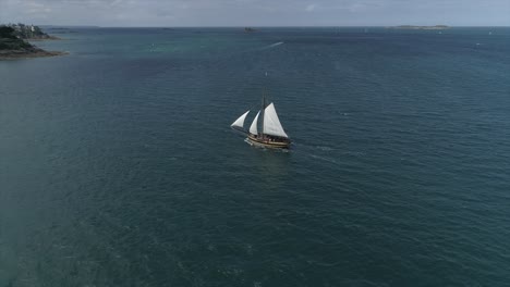 Drone-footage-of-Le-Renard,-corsair-boat-in-the-sea,-Saint-Malo,-Bretagne,-France
