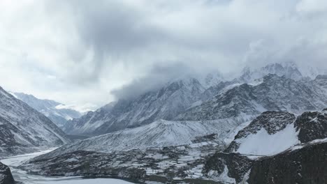 Aerial-Timelapse-Of-Clouds-Over-Snow-Covered-Mountain-Peaks-Above-Hussaini-Village-In-Hunza-Valley
