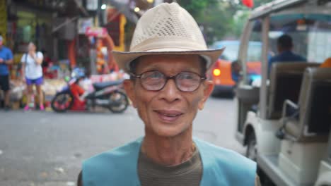 Old-working-man-walking-through-the-streets-of-Hanoi,-Vietnam