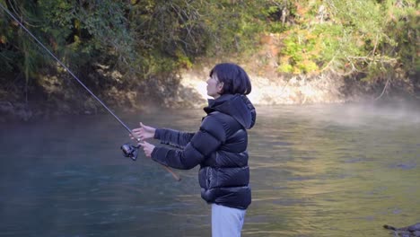 Bank-Fishing---Woman-Throwing-Bait-Into-The-Water,-Angling-With-Fishing-Rod-In-The-River