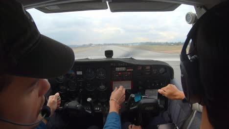 Flight-Instructor-And-Student-Pilot-In-The-Plane-Cockpit-Taking-Off-At-The-Airport