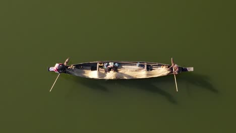fisherman-preparing-fishnet-on-small-wooden-boat-in-Bangladesh