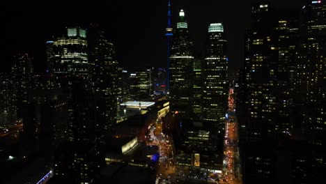 Drone-shot-flying-through-Toronto-at-night-looking-towards-the-CN-Tower