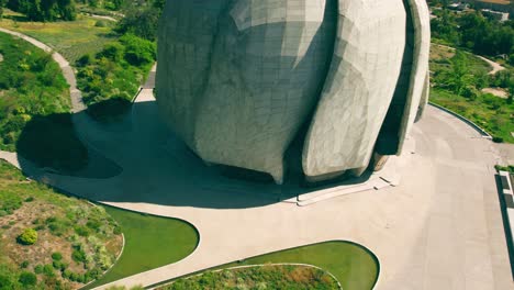 Fly-over-truck-left-of-the-spiral-design-of-the-Bahai-temple-in-South-America-on-a-sunny-and-lonely-day-with-curving-roads-and-fountains-on-the-side