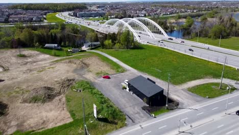 Aerial-view-of-cars-crossing-a-bridge-over-a-river-on-a-spring-day-in-Nepean