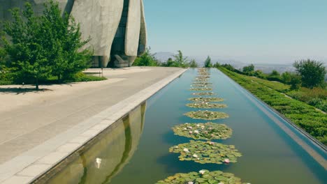 General-view-of-the-lotus-filled-fountain-with-the-reflection-of-the-architecture-of-the-Bahai-Temple-of-South-America-on-a-sunny-and-solitary-day