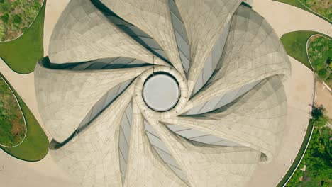 Aerial-boom-up-view-of-the-wraparound-architecture,-spiral-design-of-the-Bahai-Temple-of-South-America,-Santiago,-Chile
