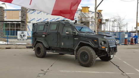 Armored-Police-Car-while-Crowds-Take-to-the-Streets-to-Demand-Change:-Freedom-Convoy-in-Windsor,-Ontario