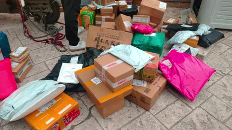 Chinese-express-delivery-courier-sorts-out-parcels-scattered-on-the-floor