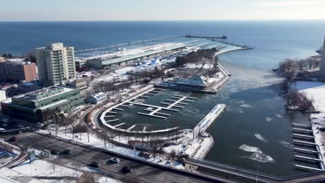 Drone-flying-towards-a-frozen-snow-covered-harbor-on-the-lakeshore-of-Mississauga