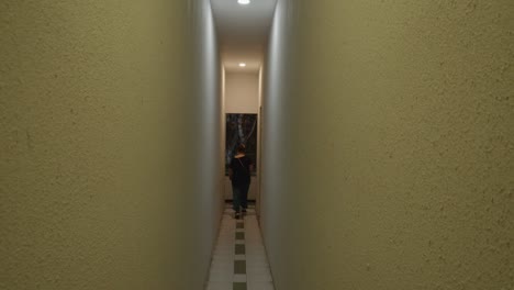 woman--walks-through-a-narrow-corridor