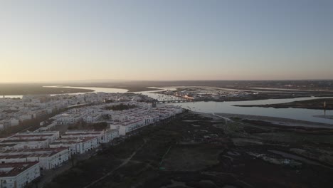 Sunset-aerial-arcing-view-over-Isla-Cristina-in-Huelva,-Spain