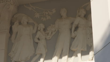 Depiction-of-family-in-a-high-relief-form,-created-in-socialist-realism-style