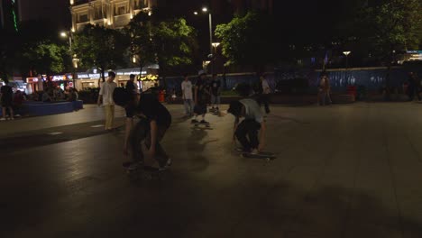 Shot-of-a-skateboarder-performing-a-flip-trick-on-a-skateboard-at-a-skatepark-at-night-in-Ho-Chi-Minh-City,-Vietnam