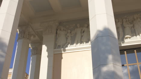 Portico-of-lofty-classicist-building-with-carved-reliefs-and-columns