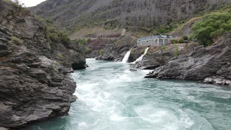 Low-flying-shot-straight-into-the-excess-water-from-the-Roaring-Meg,-hydro-power-station