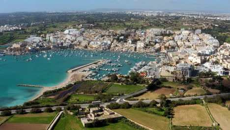 Panoramic-View-Of-Marsaxlokk-Fishing-Village-In-The-South-Eastern-Region-Of-Malta---aerial-drone-shot