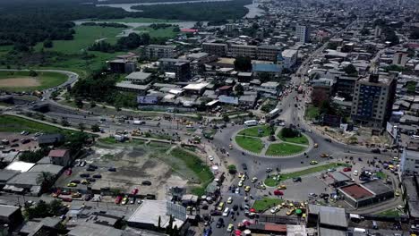 Aerial-view-of-Rond-Point-Deido-roundabout,-towards-a-industrial-area-in-Douala-city,-Cameroon---pan,-drone-shot