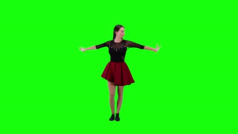 Young-charming-brunette-slowly-dancing-in-front-of-a-green-screen-background