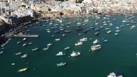 Aerial-View-Of-Harbour-Of-Marsaxlokk-Village-With-Colorful-Boats-In-Malta---drone-shot
