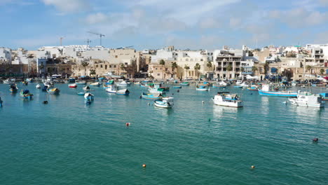 Fishing-Boats-In-Marsaxlokk-Village-In-Malta---drone-shot