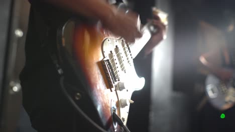 Young-person-play-with-electric-guitar-at-concert,-close-up-view