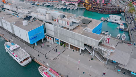 Top-view-of-people-walking-on-pier-at-Porto-Antico---view-of-Genoa-aquarium