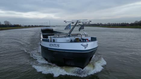 An-inland-cargo-ship-named-Venus-navigating-over-the-river-maas-near-Dordrecht