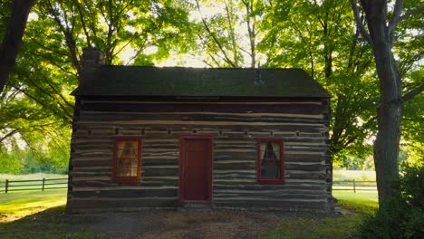 A-Shot-of-the-sun-behind-the-cabin-at-the-Historic-site-at-the-Peter-Whitmer-Farm-location-in-New-York-in-Seneca-County-near-Waterloo-Mormon-or-The-Church-of-Jesus-Christ-of-Latter-day-Saints