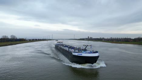 Inland-raw-material-cargo-ship-Lauma-navigating-through-the-Maas-near-Dordrecht