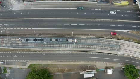 Aerial-tracking-shot-of-driving-metro-on-rail-at-Victoria-Urban-Terminal-in-Mauritius