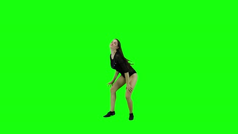 Happy-young-woman-is-dancing-and-smiling-in-front-of-a-green-screen